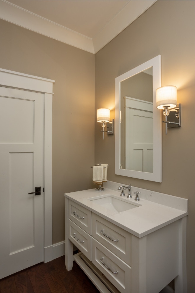 Mid-sized elegant dark wood floor and brown floor powder room photo in Other with shaker cabinets, white cabinets, beige walls, an undermount sink and a freestanding vanity