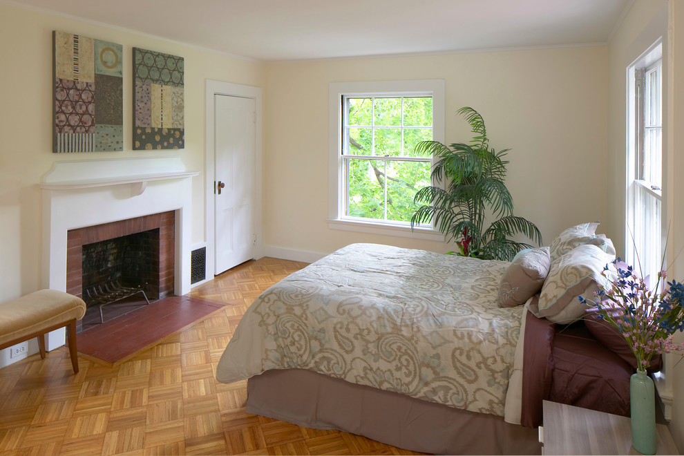 This is an example of a mid-sized contemporary guest bedroom in Boston with beige walls and light hardwood floors.