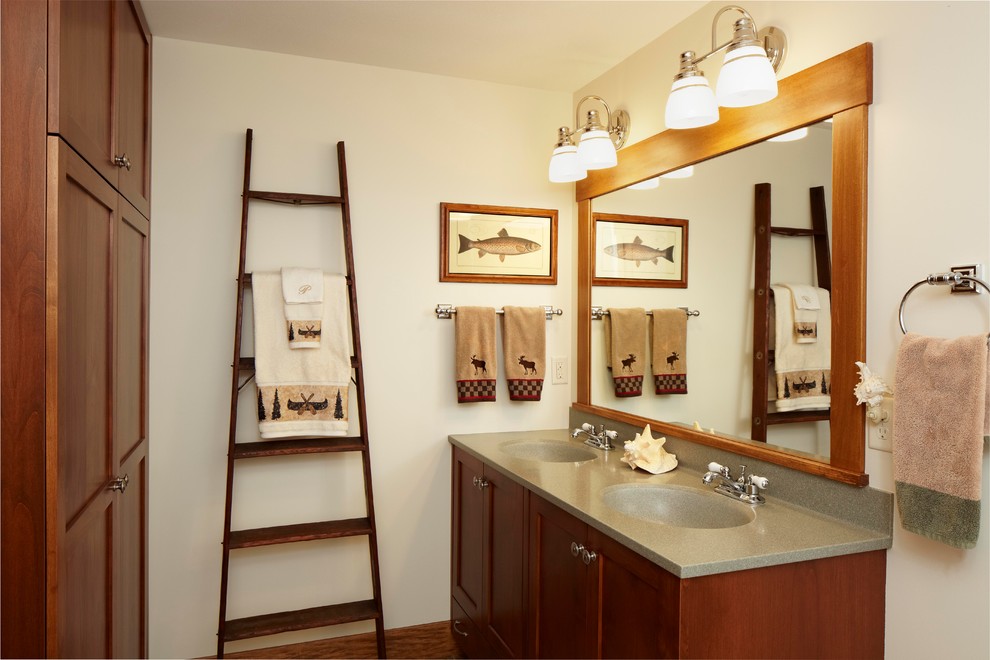 Photo of a traditional bathroom in Minneapolis with an integrated sink, shaker cabinets and medium wood cabinets.