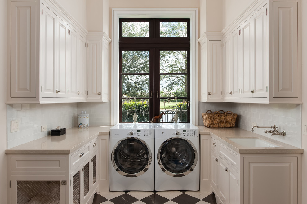 Photo of a traditional laundry room in Other with white cabinets, white walls, multi-coloured floor and beige benchtop.