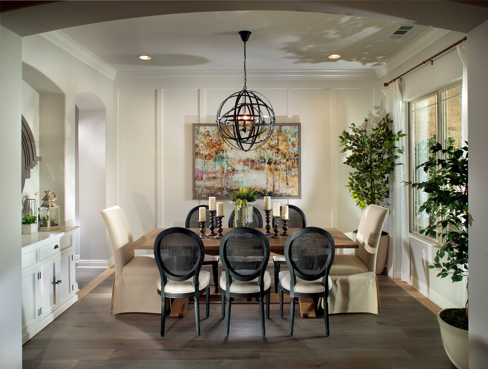 This is an example of a transitional dining room in Orange County with beige walls and dark hardwood floors.