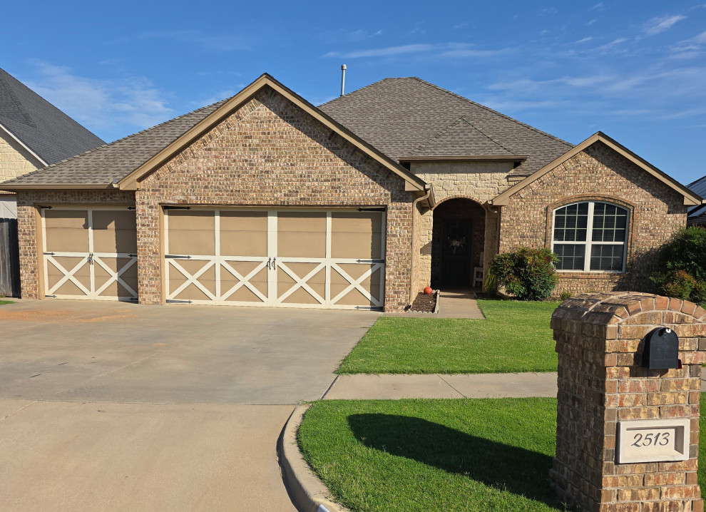 Traditional 3 car garage in stone and brick