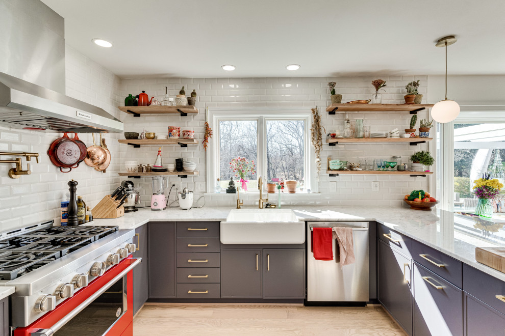 This is an example of an expansive transitional u-shaped eat-in kitchen in DC Metro with a farmhouse sink, marble benchtops, white splashback, stainless steel appliances, a peninsula and white benchtop.