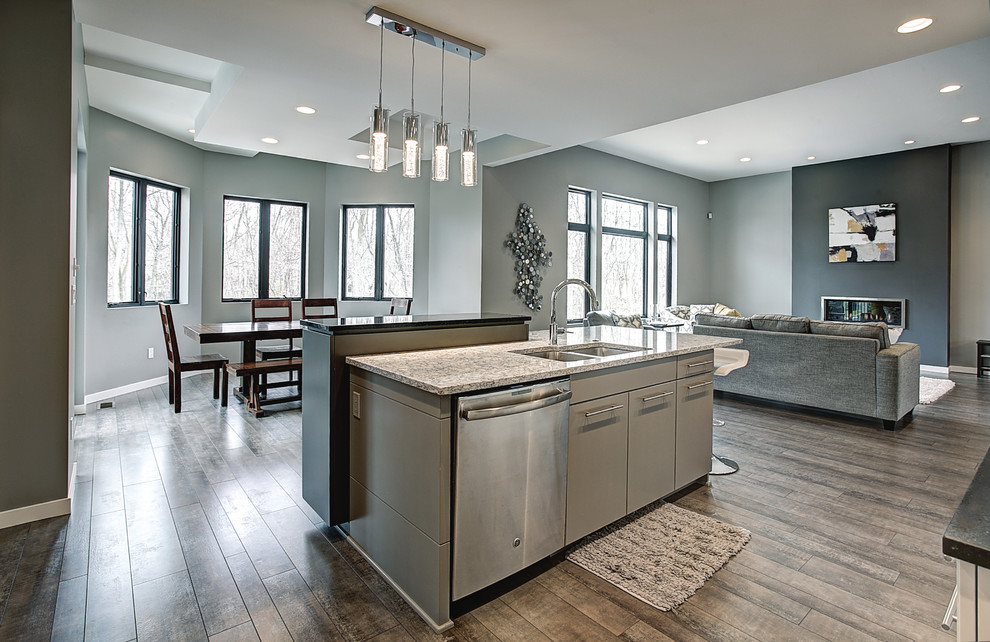 Design ideas for a contemporary galley kitchen in Grand Rapids with an undermount sink, flat-panel cabinets, white cabinets, quartz benchtops, glass tile splashback, stainless steel appliances, dark hardwood floors and with island.