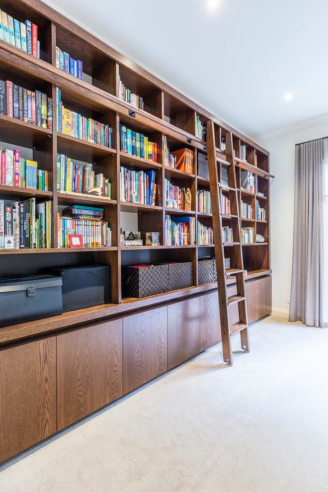 Mid-sized contemporary home office in Melbourne with a library, white walls, carpet, no fireplace and beige floor.