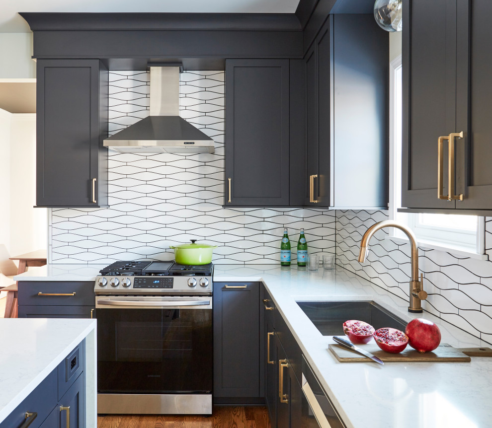 Large transitional medium tone wood floor and brown floor eat-in kitchen photo in Chicago with an undermount sink, blue cabinets, quartz countertops, white backsplash, ceramic backsplash, stainless steel appliances, an island and white countertops