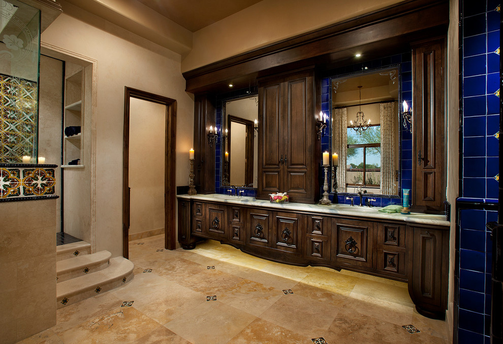Large transitional master blue tile and ceramic tile travertine floor doorless shower photo in Phoenix with an undermount sink, furniture-like cabinets, dark wood cabinets, marble countertops and beige walls