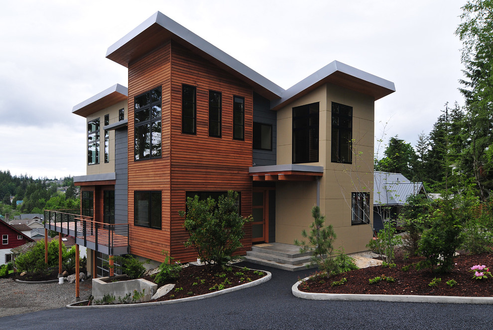 Inspiration for an expansive contemporary two-storey exterior in Seattle with mixed siding and a shed roof.