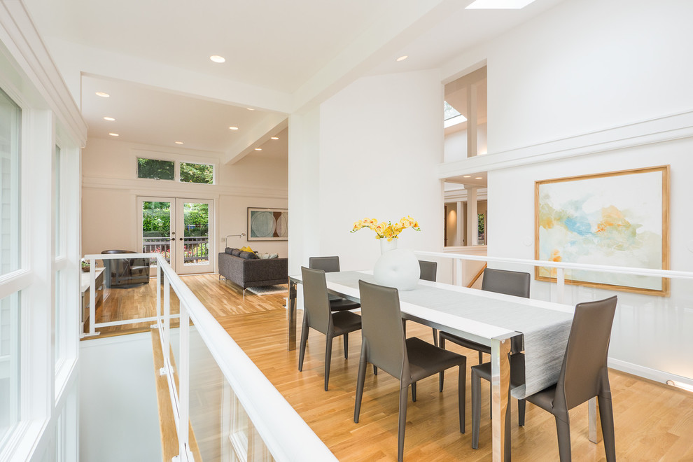 This is an example of a contemporary open plan dining in Seattle with white walls.
