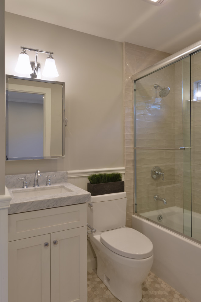 Photo of a small beach style kids bathroom in San Diego with shaker cabinets, white cabinets, an alcove tub, an alcove shower, a one-piece toilet, gray tile, subway tile, white walls, mosaic tile floors, an undermount sink and marble benchtops.