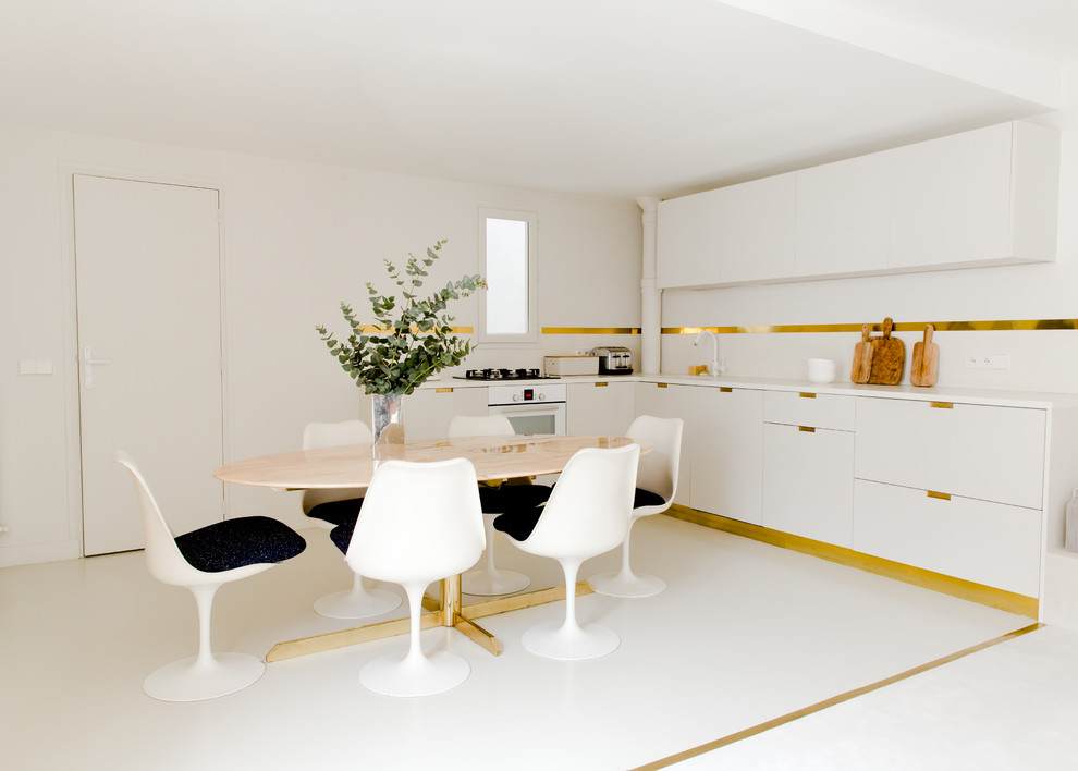 Design ideas for a large modern l-shaped eat-in kitchen in Paris with an undermount sink, beaded inset cabinets, beige cabinets, concrete benchtops, beige splashback, white appliances, concrete floors, no island, beige floor and beige benchtop.