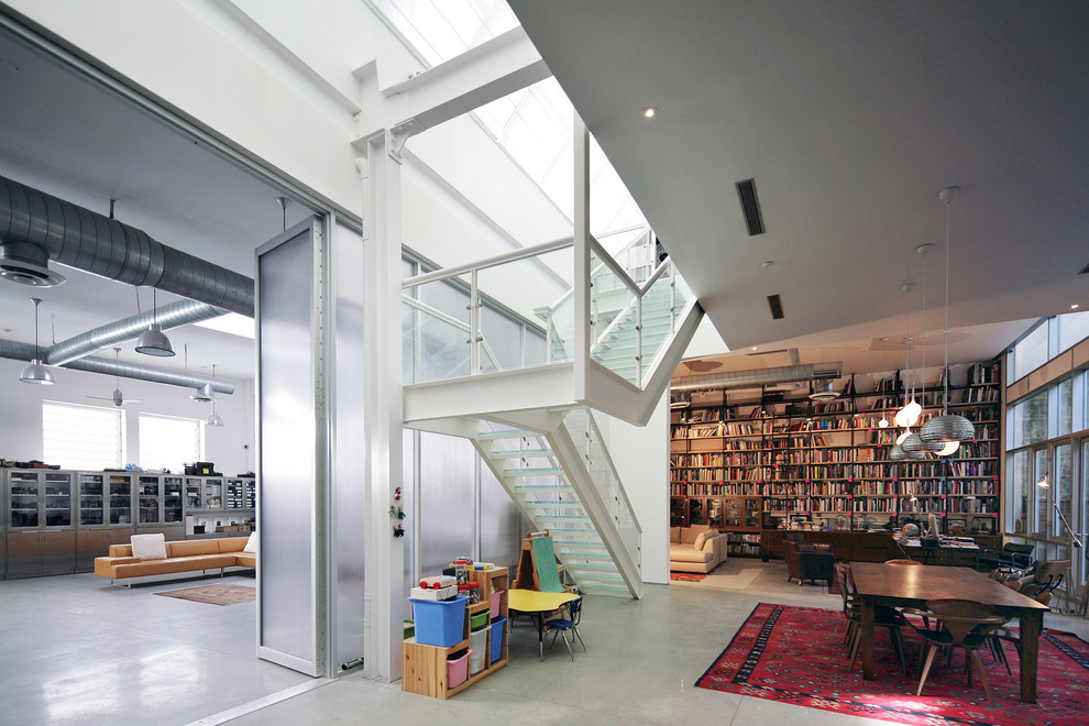 This is an example of an industrial family room in New York with a library.