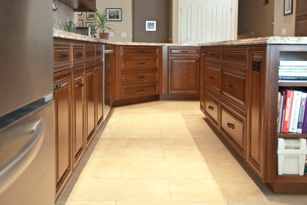 Traditional eat-in kitchen in Other with raised-panel cabinets, medium wood cabinets and granite benchtops.