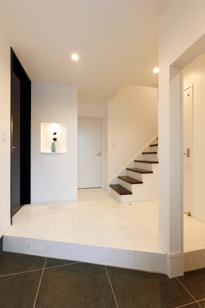 Design ideas for a contemporary entryway in Other with metallic walls and white floor.