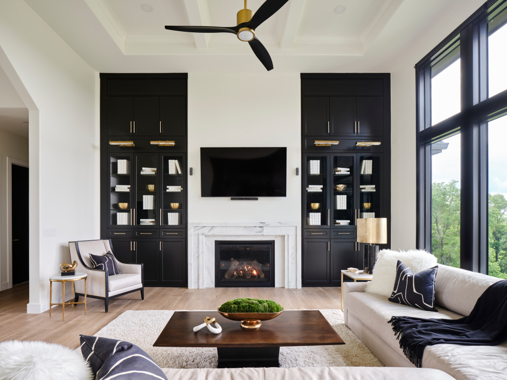 Photo of a large country open concept living room in Omaha with white walls, porcelain floors, a standard fireplace, a stone fireplace surround, a built-in media wall, beige floor and coffered.
