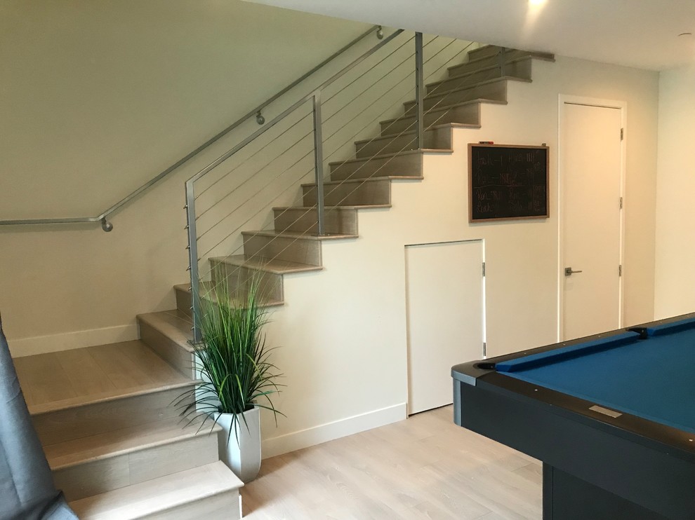 Photo of a mid-sized contemporary wood l-shaped staircase in Los Angeles with wood risers and cable railing.