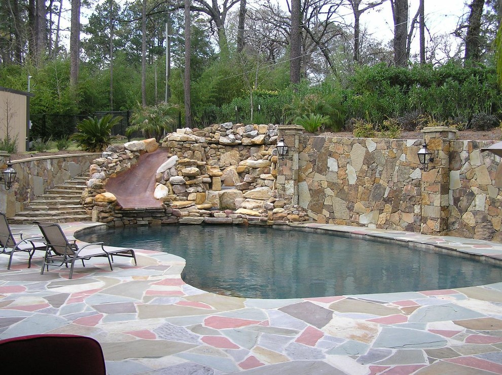 Inspiration for a mid-sized transitional backyard concrete paver and kidney-shaped water slide remodel in New Orleans