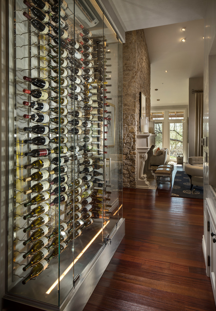 Mid-sized contemporary wine cellar in Phoenix with plywood floors, display racks and brown floor.
