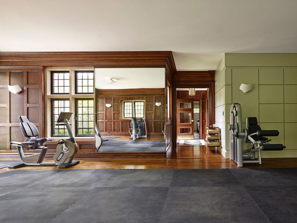 This is an example of a transitional home weight room in Toronto with multi-coloured walls and dark hardwood floors.