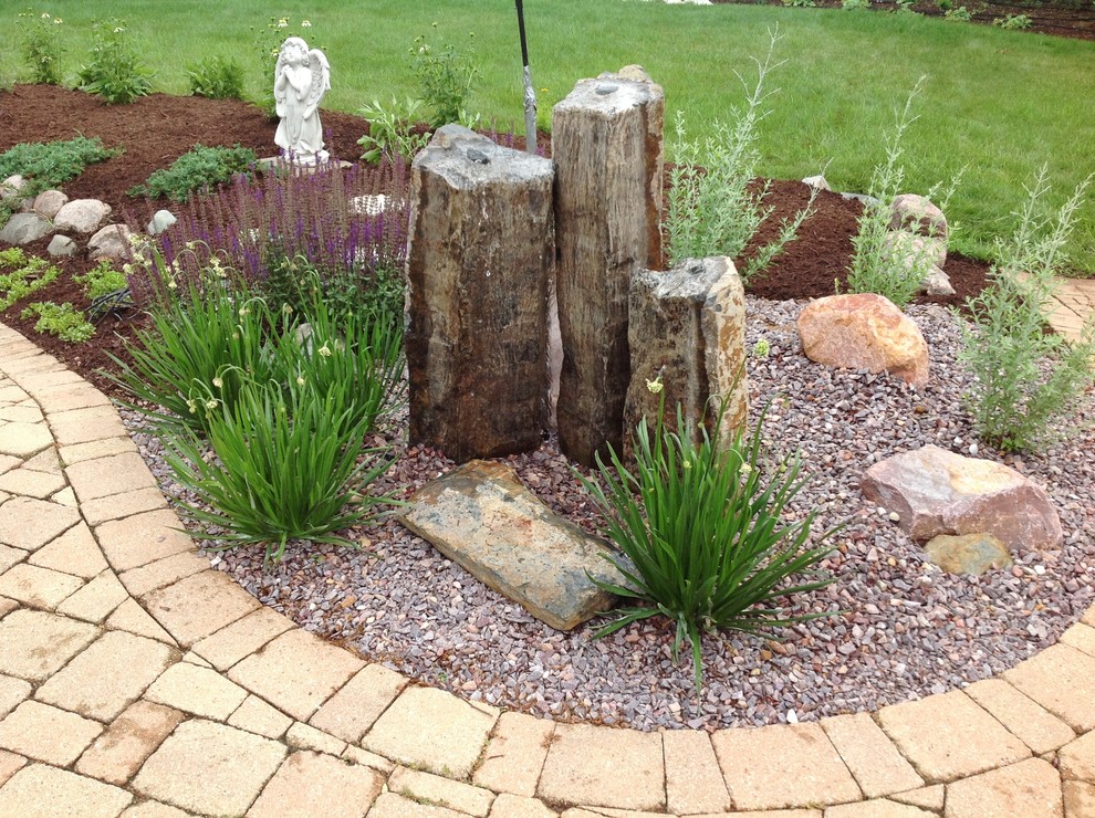 This is an example of a contemporary backyard stone formal garden in Chicago for summer.