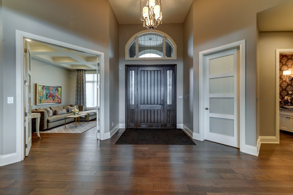 Inspiration for a transitional dark wood floor foyer remodel in Edmonton with a dark wood front door and gray walls