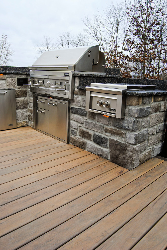 Photo of a mid-sized traditional backyard deck in Philadelphia with an outdoor kitchen and an awning.
