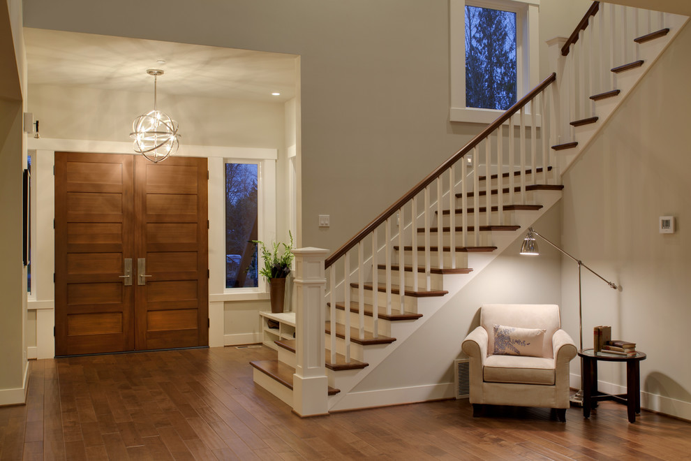 Design ideas for a transitional foyer in Seattle with beige walls, a double front door and a medium wood front door.