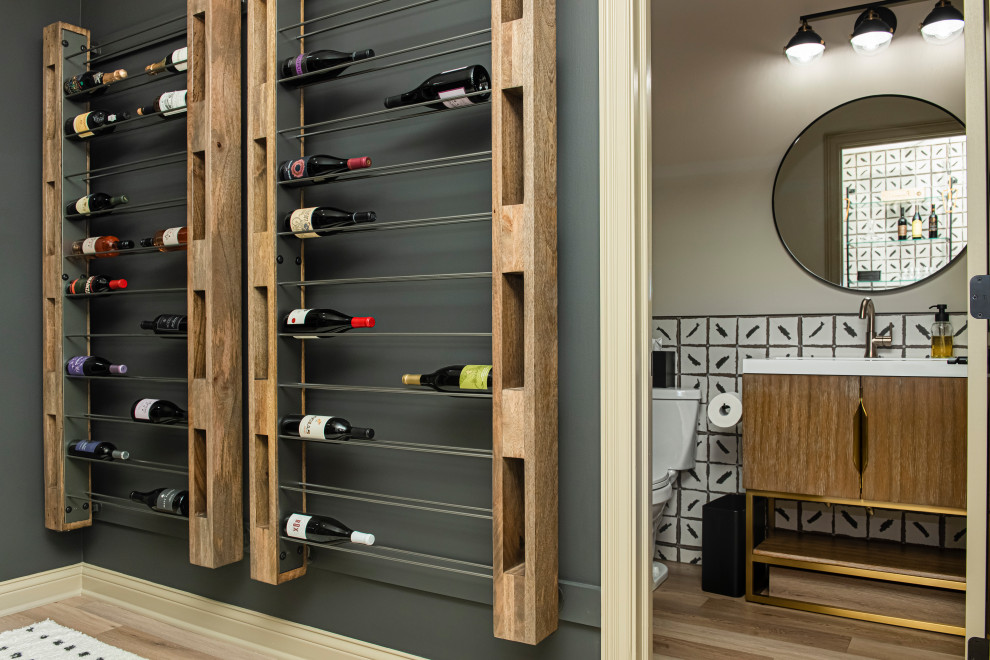 Design ideas for a mid-sized contemporary wine cellar in Indianapolis with light hardwood floors, storage racks and brown floor.