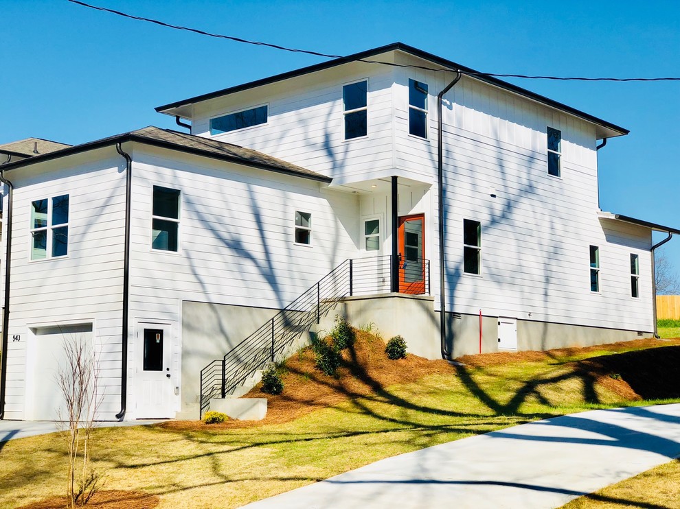 Example of a mid-sized minimalist white two-story house exterior design in Atlanta