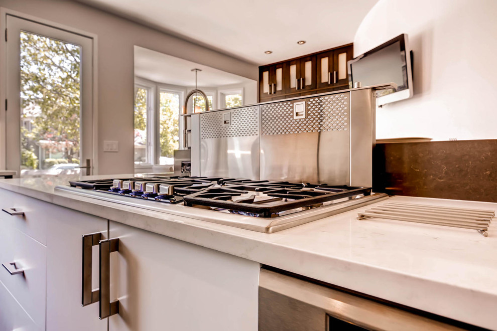 Eat-in kitchen - large transitional dark wood floor eat-in kitchen idea in Denver with an undermount sink, flat-panel cabinets, white cabinets, quartz countertops, stainless steel appliances and two islands