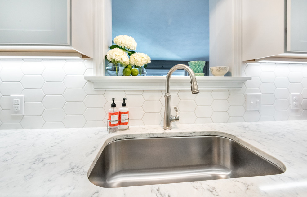 Transitional medium tone wood floor kitchen photo in Richmond with a single-bowl sink, shaker cabinets, white cabinets, quartzite countertops, white backsplash, mosaic tile backsplash, stainless steel appliances and a peninsula