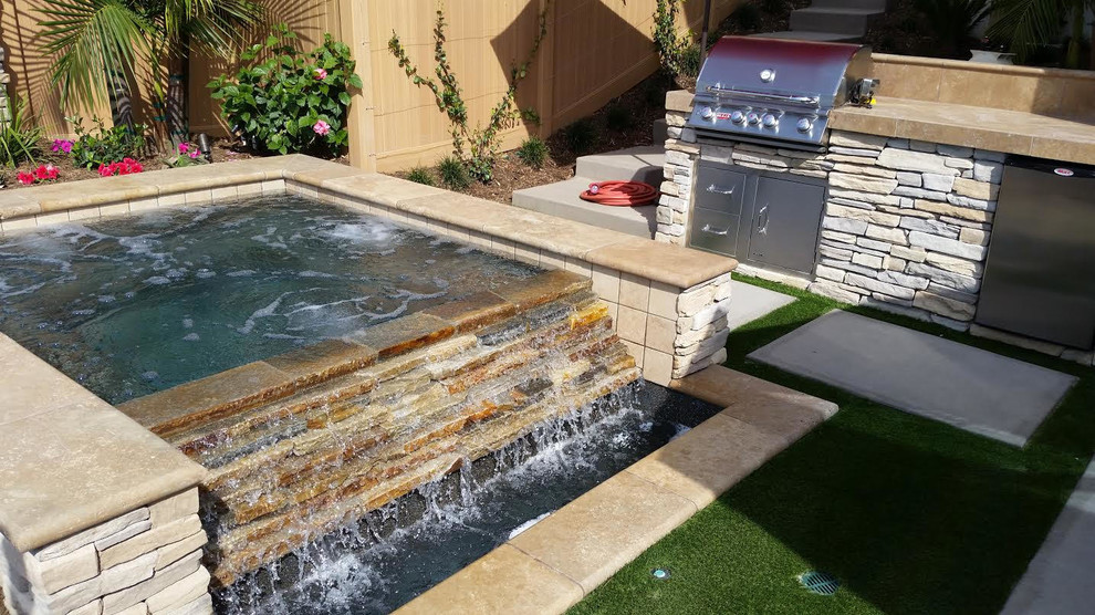 Example of a mid-sized classic backyard concrete paver and rectangular lap pool fountain design in Orange County