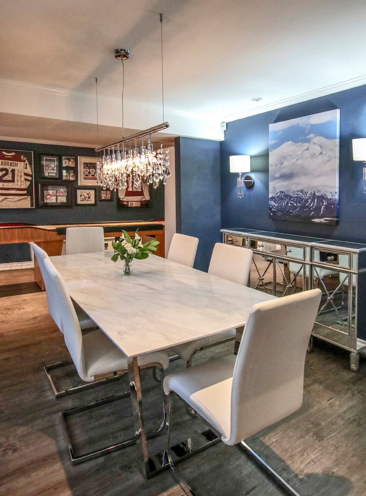 This is an example of a mid-sized transitional dining room in Toronto with blue walls, vinyl floors, a corner fireplace, a tile fireplace surround and grey floor.