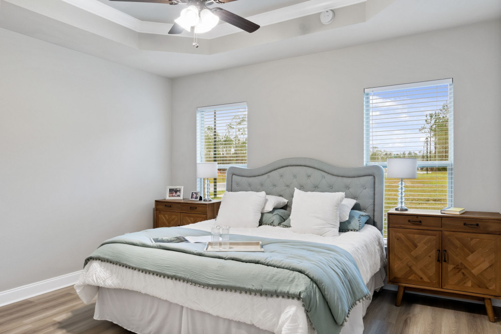 This is an example of a medium sized traditional master bedroom in Other with beige walls and brown floors.
