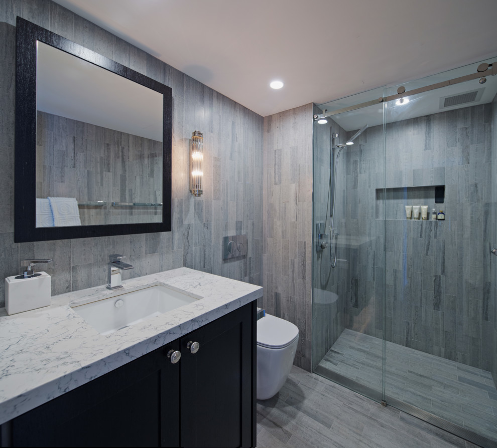 Small contemporary 3/4 bathroom in Sydney with shaker cabinets, black cabinets, an alcove shower, a one-piece toilet, gray tile, travertine, grey walls, marble floors, an undermount sink, engineered quartz benchtops, grey floor and a sliding shower screen.