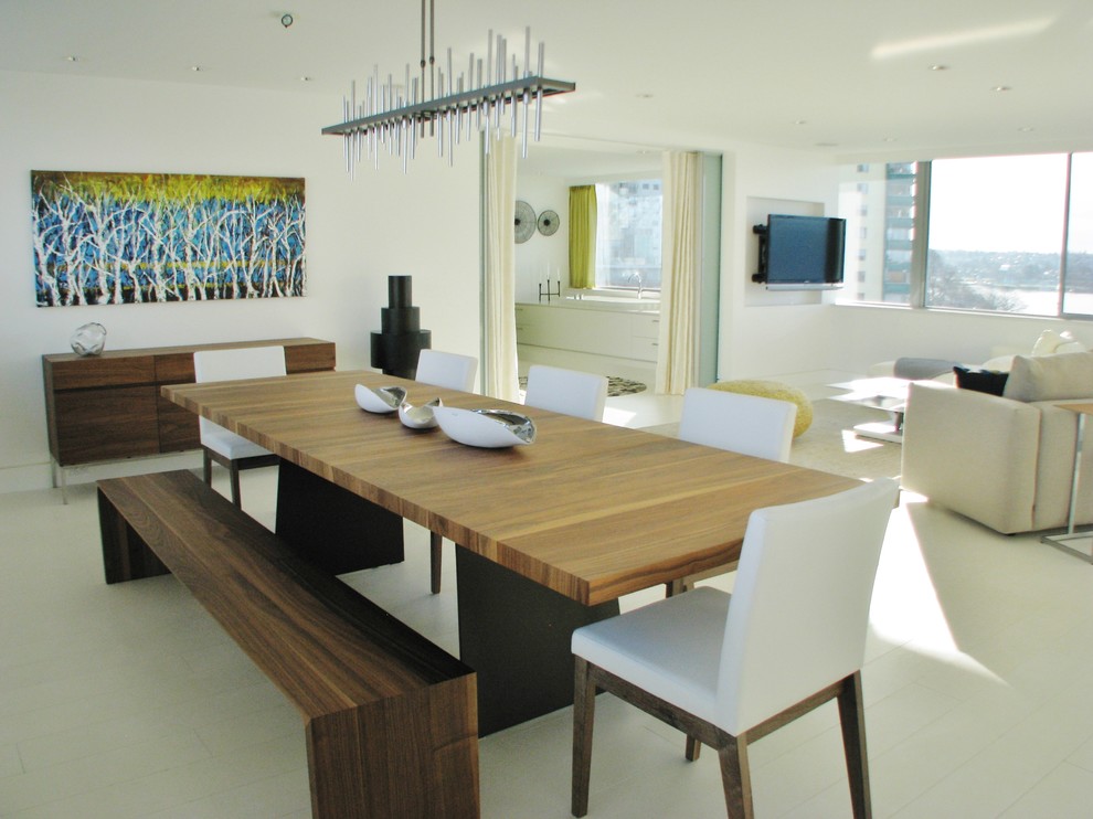 This is an example of a large contemporary dining room in Vancouver with white walls, ceramic floors, no fireplace and white floor.