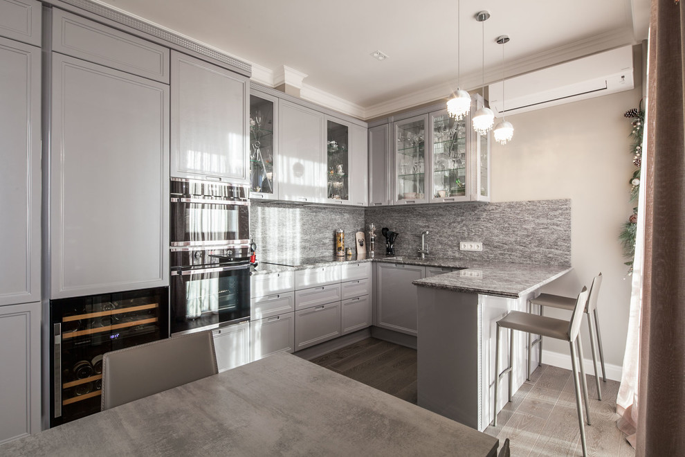 Inspiration for a transitional u-shaped kitchen in Moscow with recessed-panel cabinets, grey cabinets, grey splashback and black appliances.