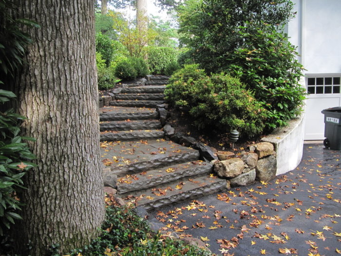 This is an example of a traditional front yard garden in New York with natural stone pavers.