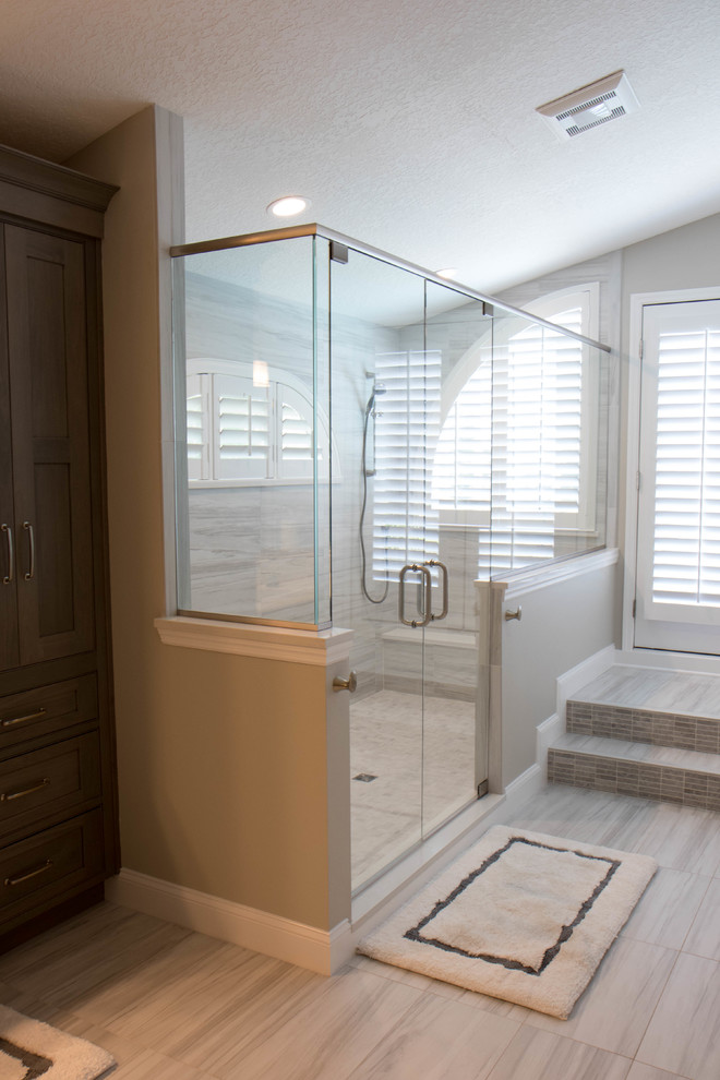 Design ideas for an expansive transitional master bathroom in Orlando with recessed-panel cabinets, grey cabinets, grey walls, porcelain floors, an undermount sink, quartzite benchtops, grey floor, a hinged shower door, white benchtops, a double shower, gray tile and porcelain tile.