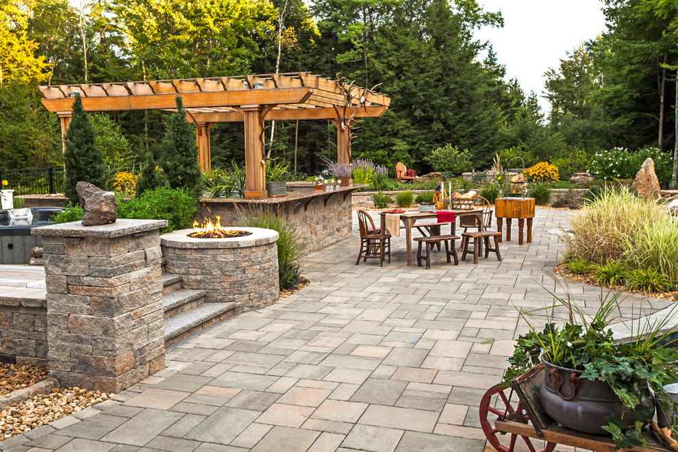 This is an example of a mid-sized traditional backyard patio in Other.