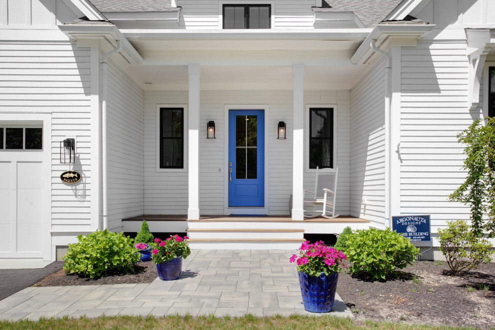 Photo of a mid-sized country front door in Other with white walls, light hardwood floors, a single front door and a blue front door.