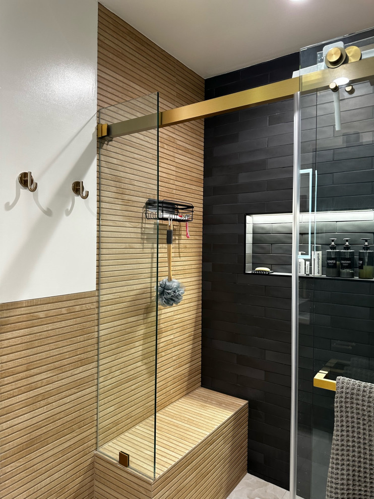 Photo of a large shower room bathroom in Los Angeles with shaker cabinets, black cabinets, a corner shower, a one-piece toilet, brown tiles, wood-effect tiles, white walls, ceramic flooring, a built-in sink, quartz worktops, white floors, a sliding door, white worktops, double sinks and a freestanding vanity unit.