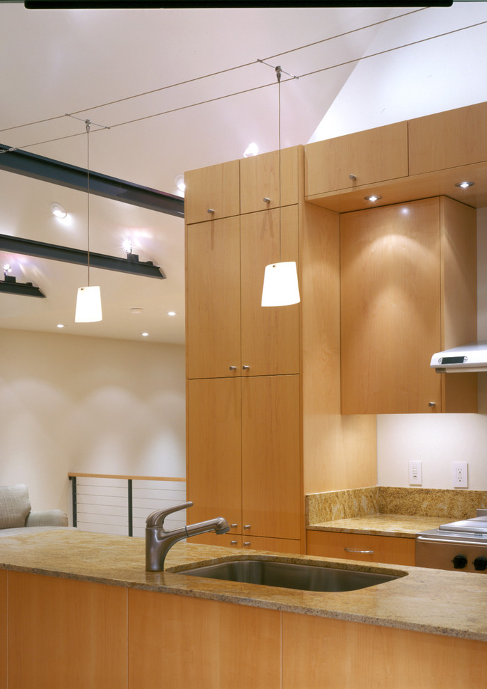This is an example of a contemporary kitchen in San Francisco with an undermount sink, flat-panel cabinets and medium wood cabinets.