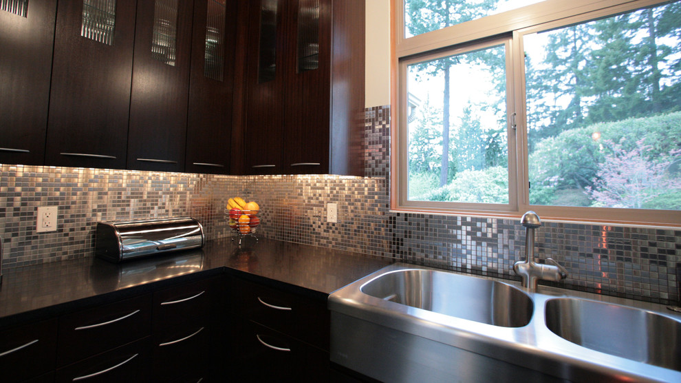 This is an example of a contemporary kitchen in Phoenix with flat-panel cabinets and dark wood cabinets.