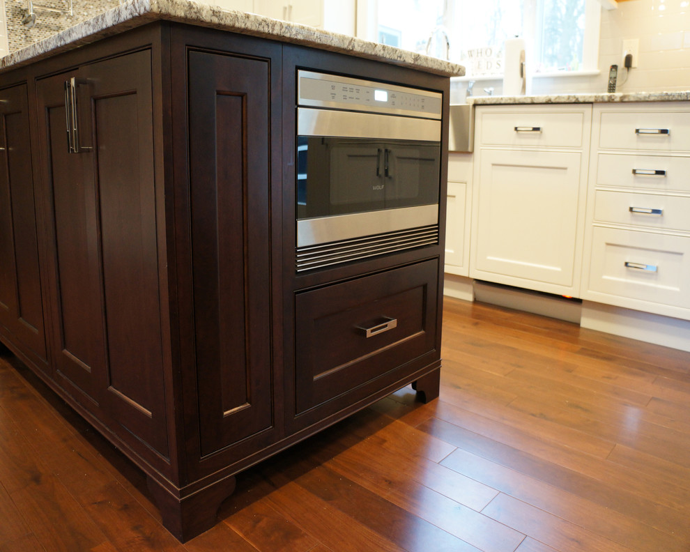 Example of a mid-sized galley dark wood floor eat-in kitchen design in Boston with an island, white cabinets, stainless steel appliances, an undermount sink, recessed-panel cabinets, wood countertops, gray backsplash and stone tile backsplash