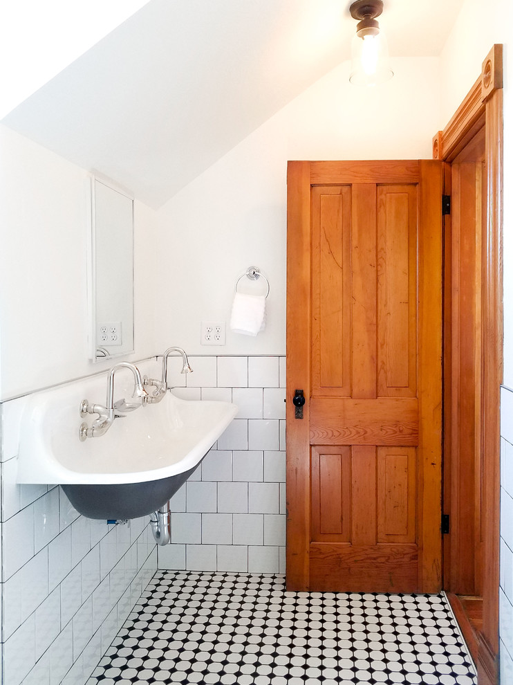 Design ideas for a small traditional kids bathroom in Boise with open cabinets, a claw-foot tub, a shower/bathtub combo, a one-piece toilet, white tile, ceramic tile, white walls, ceramic floors, a wall-mount sink, black floor, a shower curtain and white benchtops.