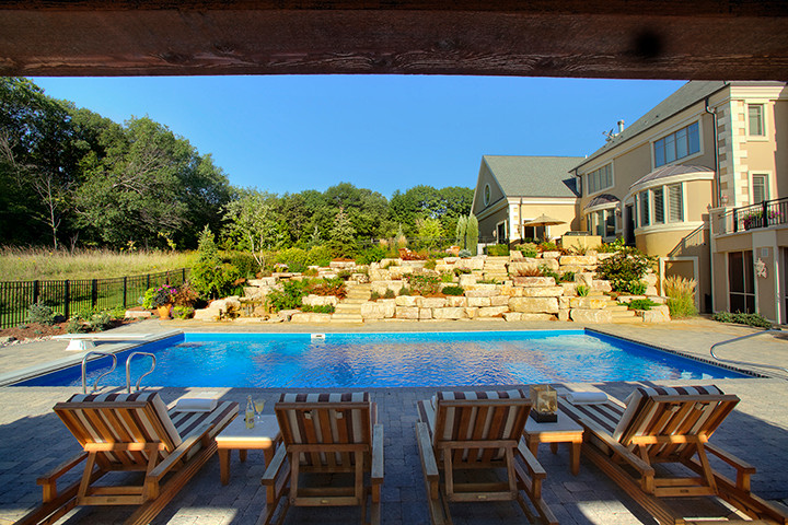 Transitional backyard brick and rectangular pool house photo in Minneapolis