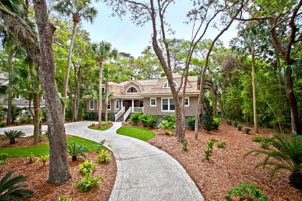 Photo of a one-storey brown house exterior in Charleston with a gambrel roof and a shingle roof.
