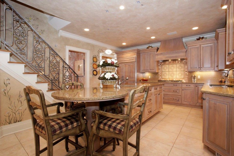 Example of a large transitional u-shaped ceramic tile and beige floor enclosed kitchen design with granite countertops, beige backsplash, a single-bowl sink, raised-panel cabinets, light wood cabinets, mosaic tile backsplash, paneled appliances and an island