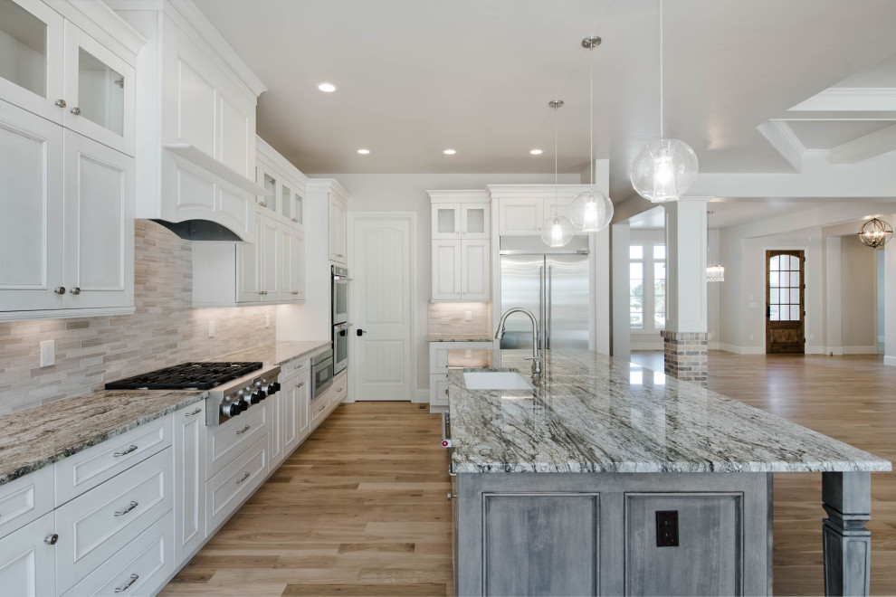 Large transitional l-shaped light wood floor and brown floor eat-in kitchen photo in Denver with an undermount sink, flat-panel cabinets, gray cabinets, granite countertops, beige backsplash, stainless steel appliances, an island and gray countertops